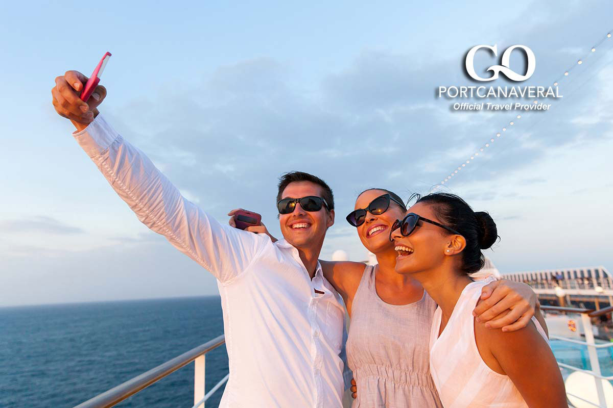 group of friends taking self portrait using smart phone on cruise