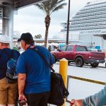 Line of cruise passengers getting on Go Port shuttle after disembarking at Port Canaveral