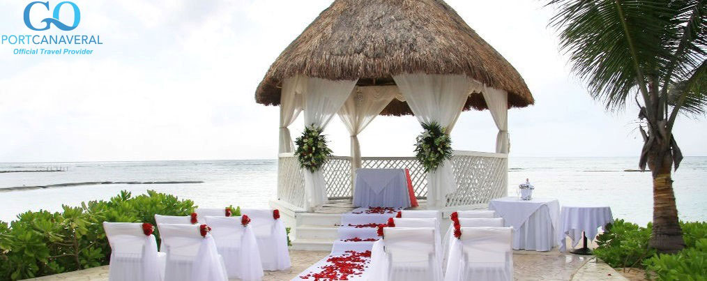 Tropical beach wedding location with rose petals scattered on the isle.