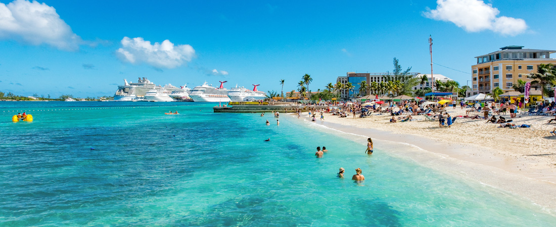 Walking to Junkanoo Beach in Nassau, Bahamas with cruise ships in the back