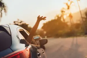 cruiser waving hand from car window as it drives down road to port canaveral