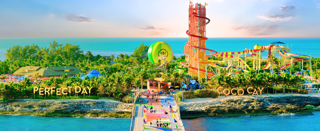 Aerial and panoramic view of Perfect Day of Coco Cay Island with walkway and green hot air balloon with colorful water slides and Royal Caribbean logo. 