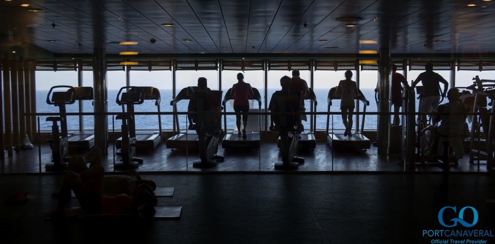 people working hard to stay fit in the gym onboard