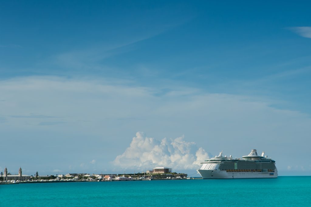 Cruise ship docked in beautiful blue Bermuda water.