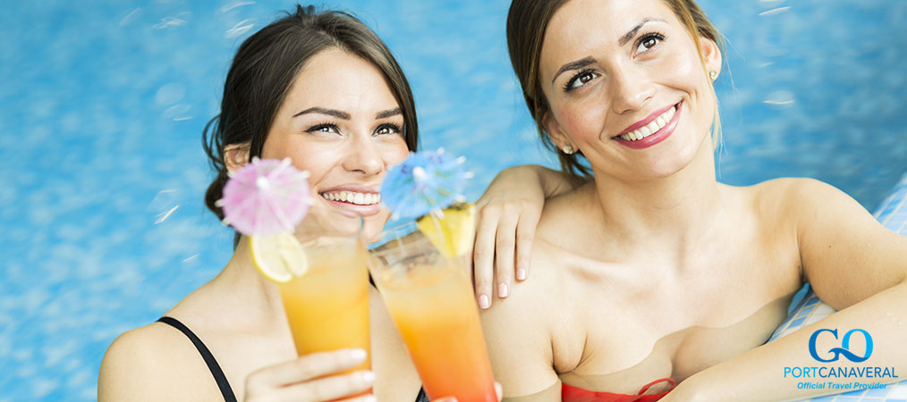 women enjoying alcoholic beverages by the pool