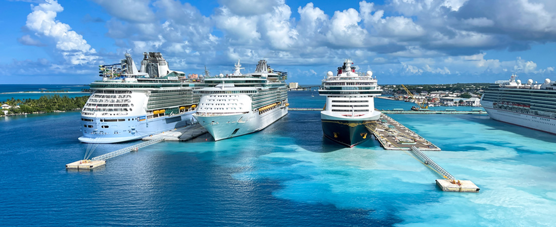 3 cruise ships on the water docked at port nassau bahamas with blue skies in the background