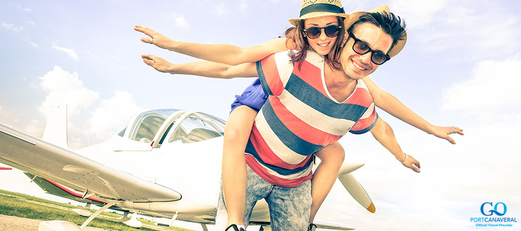 couple by airplane acting like they're flying