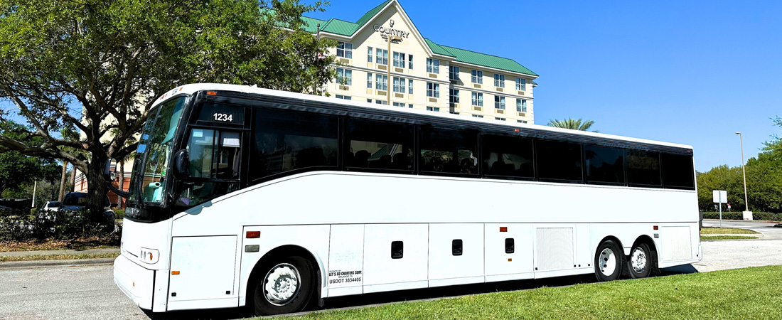 white cruise shuttle parked in front of hotel