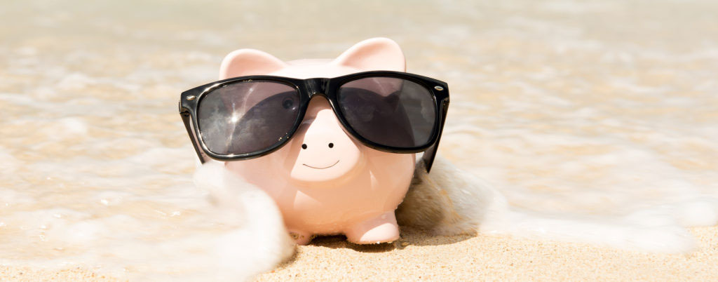 Piggy bank on the beach, blanketed in sea water