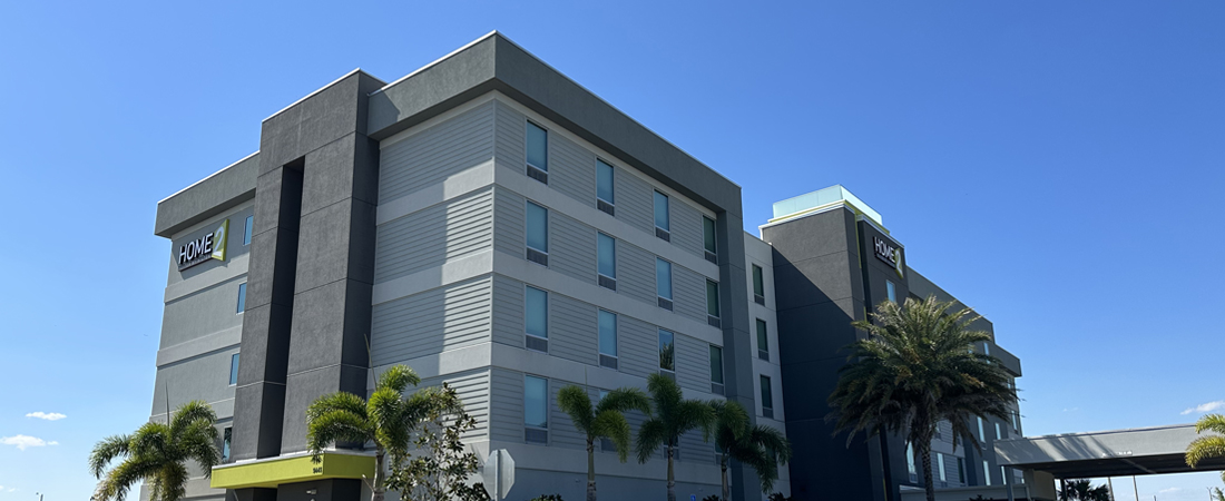 Zoomed out view of Home2 Suites Orlando Airport Hotel gray building