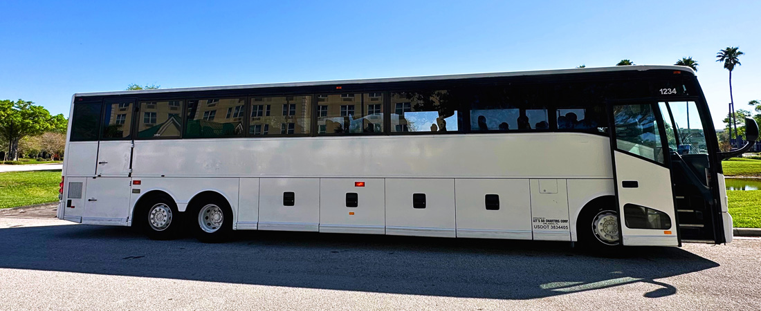 White coach bus parked, pre-arranged cruise transfer with door open waiting for guests