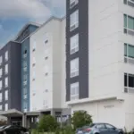 towneplace suites exterior: white and navy blue building with parking lot