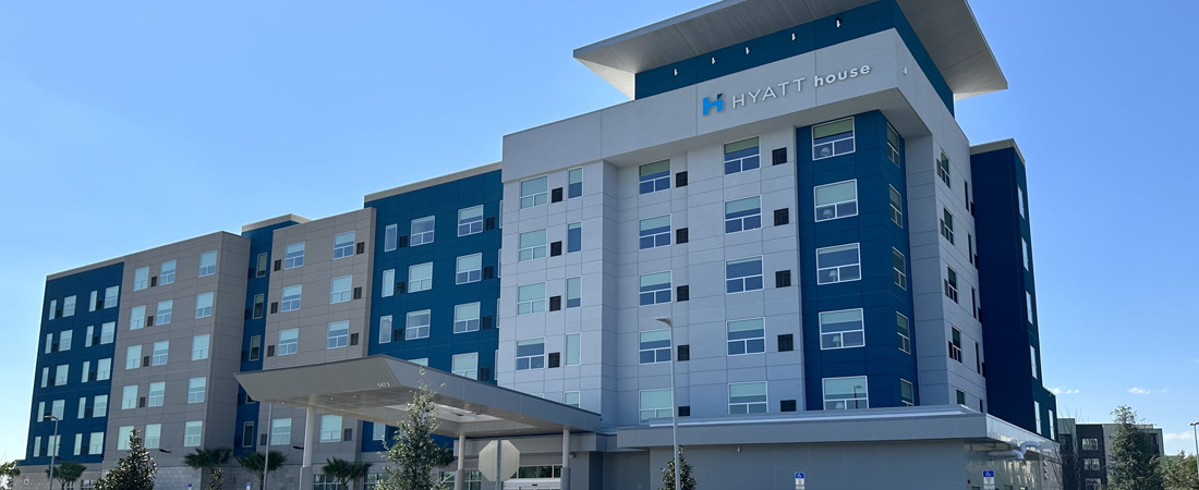 Hyatt House Orlando Airport hotel exterior with blue and white mix and match walls
