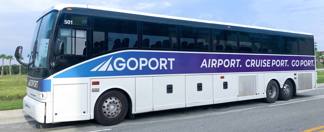 Large Port Canaveral shuttle bus with Go Port's logo that says Airport. Cruise Port. Go Port. on the side