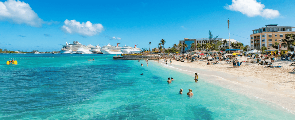 Walking to Junkanoo Beach in Nassau, Bahamas with cruise ships in the back
