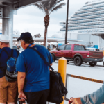 Line of cruise passengers getting on Go Port shuttle after disembarking at Port Canaveral