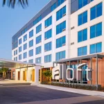 Experience Ultimate Pre-Cruise Comfort with Go Port's New Aloft Orlando Lake Nona Partnership Exterior View of front of Aloft Orlando Lake Nona hotel