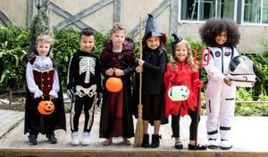 Kids in Halloween costumes enjoying festive activities on a cruise