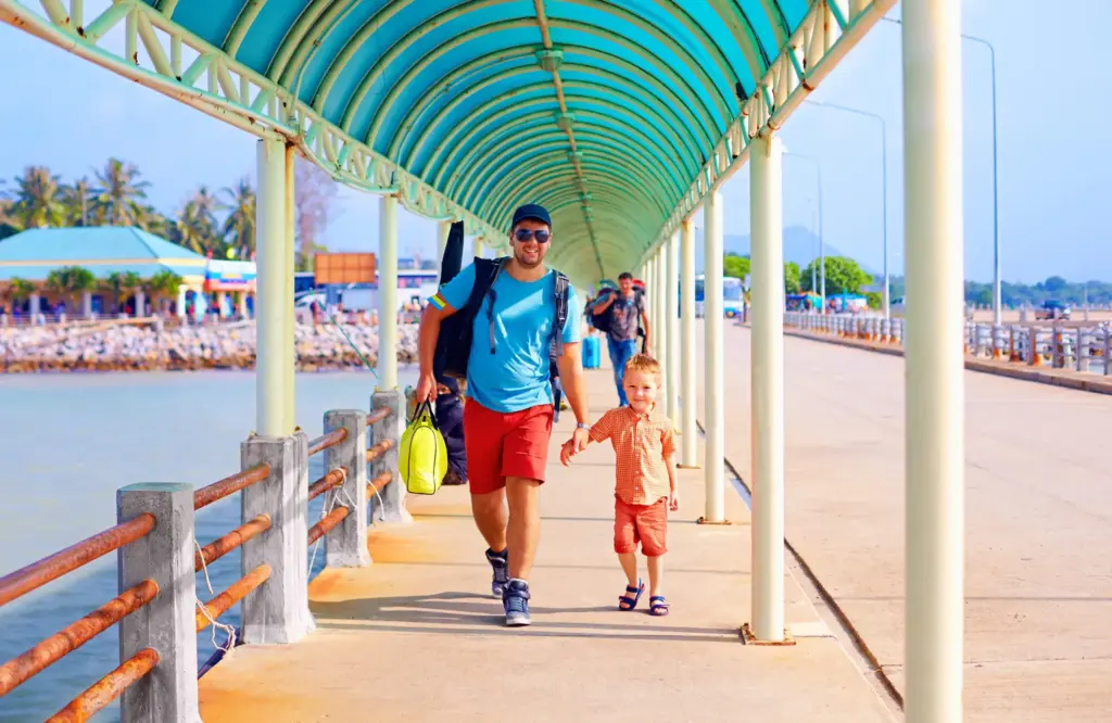 Father and son walking to onboard the cruise ship