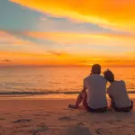 Couple cuddled up on the beach