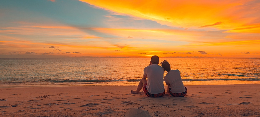 Couple cuddled up on the beach