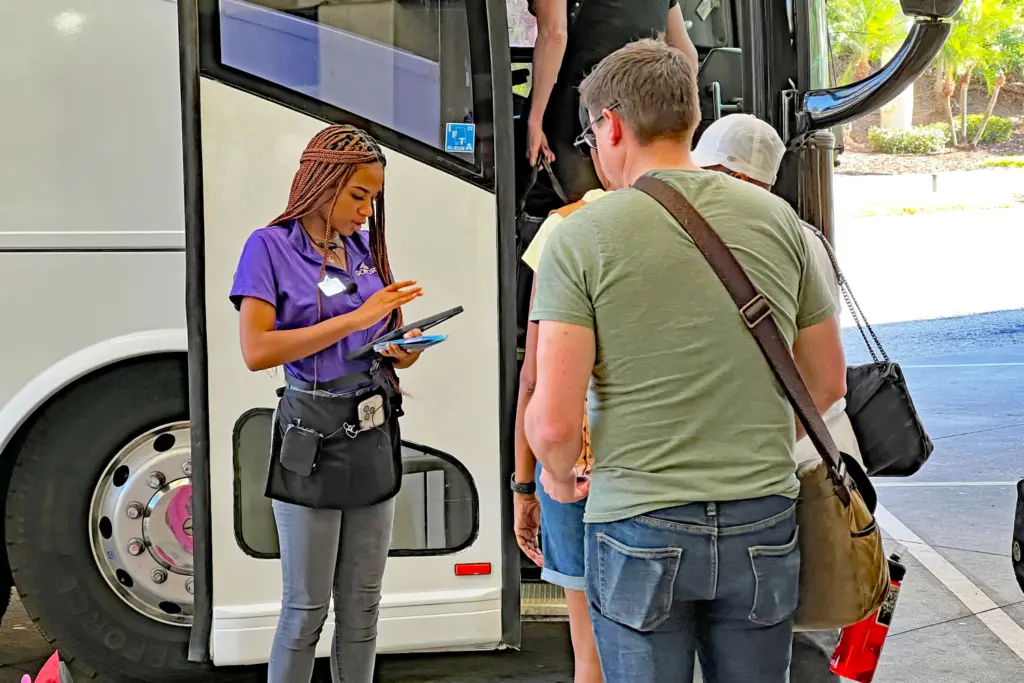 Our Go Port greeters check in guests as they line up to board their motorcoach at MCO.