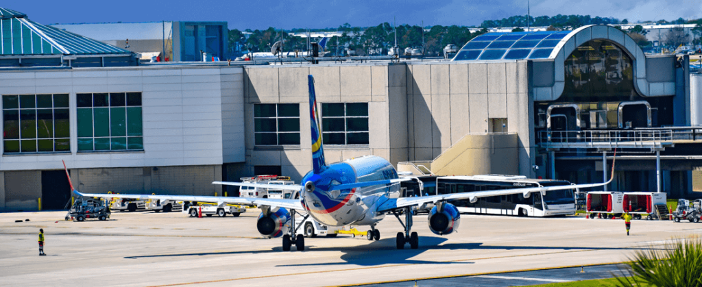 Blue airplane parked on tarmac