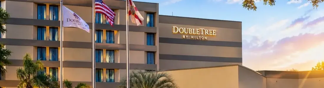 Exterior of DoubleTree by Hilton Orlando east near UCF with sunset in background
